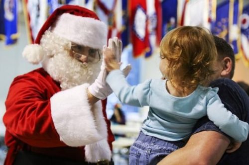 Featured Image Of Santa Greeting Children One He Is Hi Fiveing.
