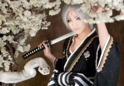 Image Of A Japanese Woman In Kimono Carrying A Sword Whilst Nearby In White Flowery Vines Is A White Snake.