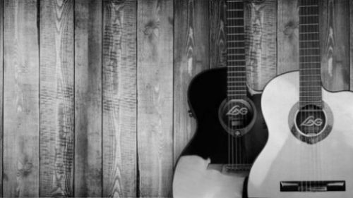 photocredit/thanks:pixabay Featured Image Of A Black And White Guitar Leaning Against A Wood Fence.
