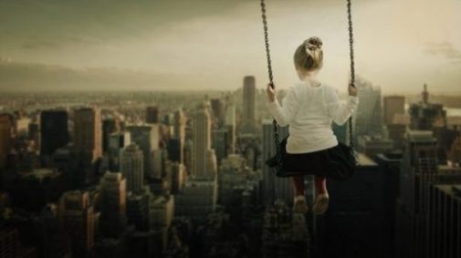 Featured Image Of A Young Girl On A Swing Overlooking Suburbia.