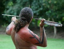 Image From Behind Of An Australian Aboriginal Warrior Holding A Woomera And Spear Ready To Throw.