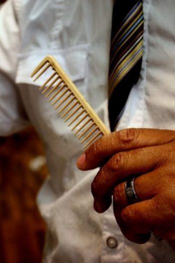 Featured Topic Image Man With White Shirt, Striped Tie Holds A Comb. Focus On Comb.