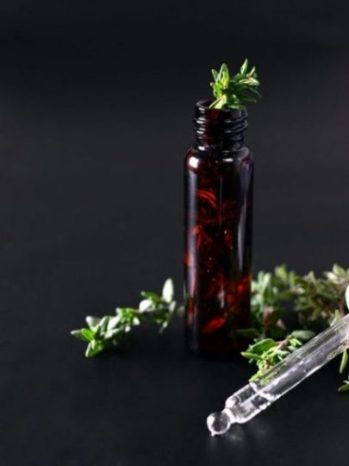Featured Topic Image A Pipette Lying Amongst Thyme Buds, A Small Bottle With A Thyme Stem Inserted.