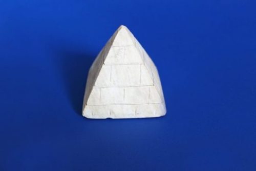 Featured Image White Pyramid Shaped Block On Dark Blue Background.