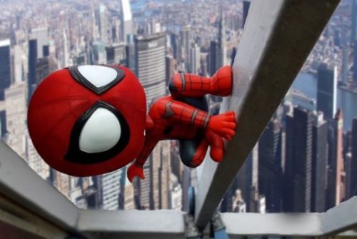 Featured Image Fantasy Toy Super Hero Spiderman Climbs Hi Rise Building In A City Day Scene.
