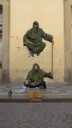 Featured Topic Image Two Cloaked Street Magicians Performing Levitation.