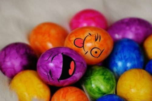 photocredit/thanks:Alexas_Fotos:pixabay Featured Topic Image Lying Amidst Atop A Pile Of Other Many Colored Eggs, Two With Facial Features Smile, Smirk.
