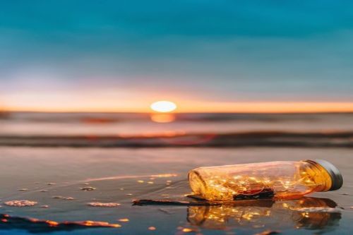 Featured Image. A Lone Jar On The Waters Edge During Sunrise/Sunset.