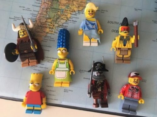 A Section Of The World Map With Several Hero/Cartoon Lego Figures Overlying.