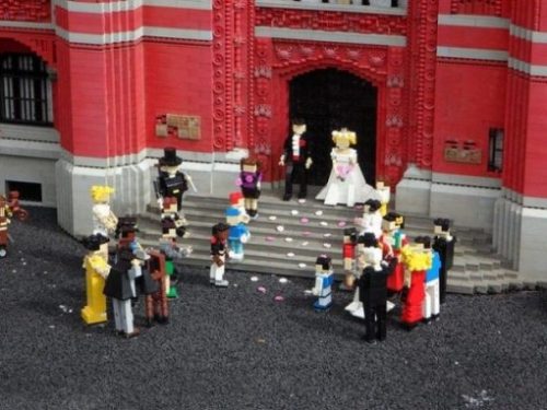A Marriage Crowd Of Lego Figures Assembled Outside A Church. Bride And Groom On Stairs At The Entrance.
