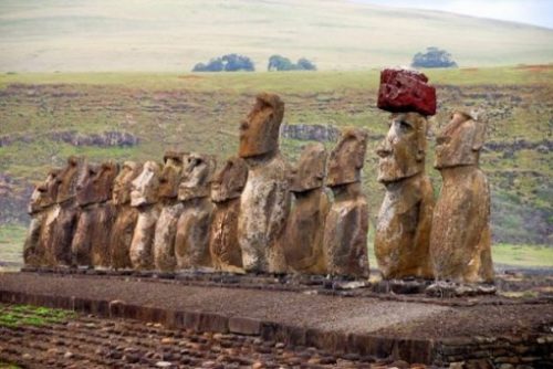 Featured Topic Image Of A Row Of Easter Island Stone Giants. Hat Is Red Stone.
