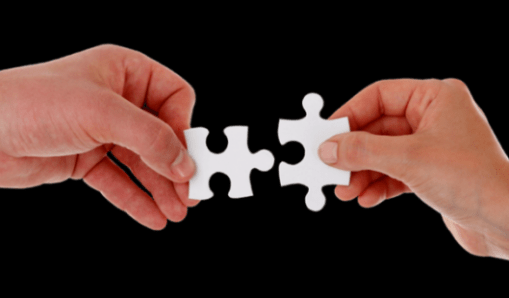 Featured Image Of A Male And Female Hand Each With A Matching Jigsaw Piece Approaching Each Other.