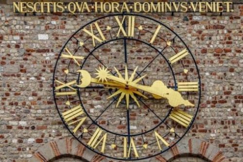 Image Of A Large Golden Ornate Clock On A Building Wall/Side.