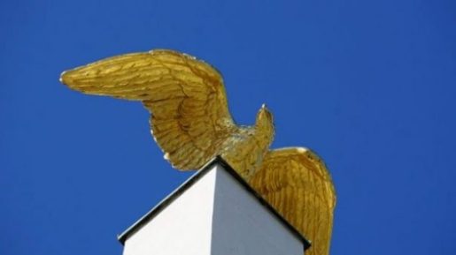 Featured Image Of A Closeup Of A Wings Spread Golden Bird Statue.