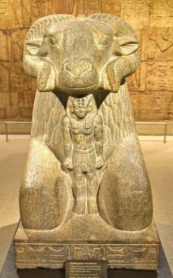 Image Of A Statue Of Amun-Ra Yore Egyptian God With Rams Head Surmounted Above.