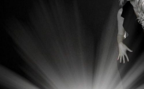 Featured Image Of A Backlit Shadowy Female Form Side On To A Spotlight Effect.